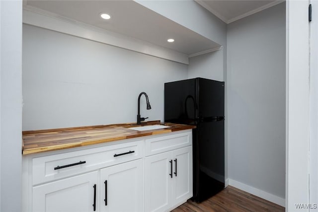 11376 Kings Loop Rd, Tuscaloosa, AL 35405 - kitchen featuring butcher block counters, freestanding refrigerator, crown molding, dark wood-style flooring, and white cabinets