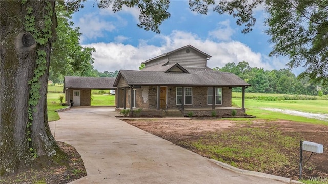11376 Kings Loop Rd, Tuscaloosa, AL 35405 - view of front facade featuring driveway, a front lawn, brick siding, and covered porch