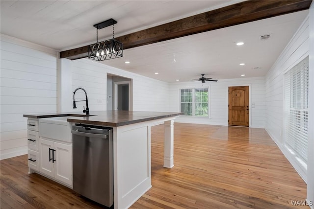 11376 Kings Loop Rd, Tuscaloosa, AL 35405 - kitchen featuring dishwasher, dark countertops, light wood-style flooring, open floor plan, and white cabinetry