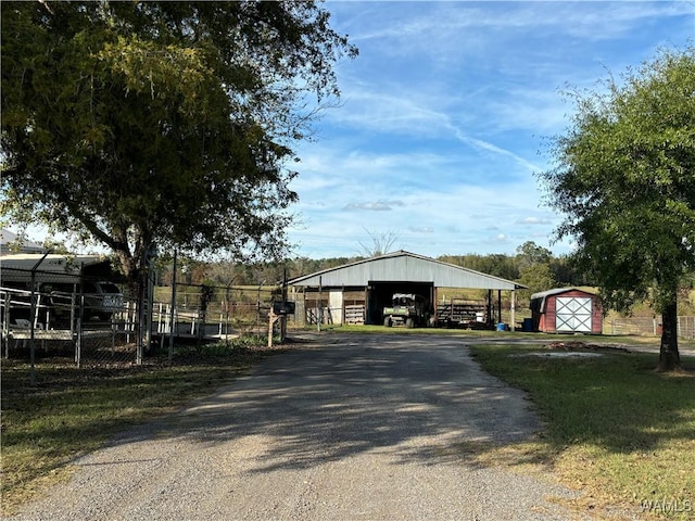 view of street with gravel driveway