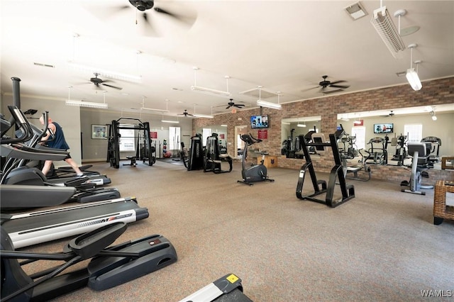 gym featuring brick wall, visible vents, and ceiling fan