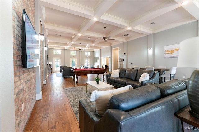 living room featuring beam ceiling, coffered ceiling, ceiling fan, hardwood / wood-style floors, and pool table