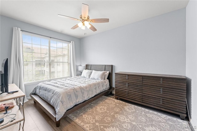 bedroom featuring baseboards and ceiling fan