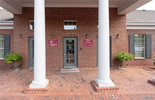 view of exterior entry with brick siding