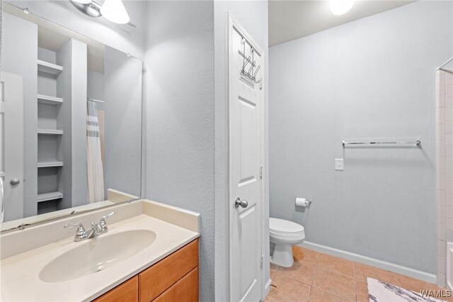 bathroom with tile patterned floors, toilet, vanity, baseboards, and a shower with shower curtain