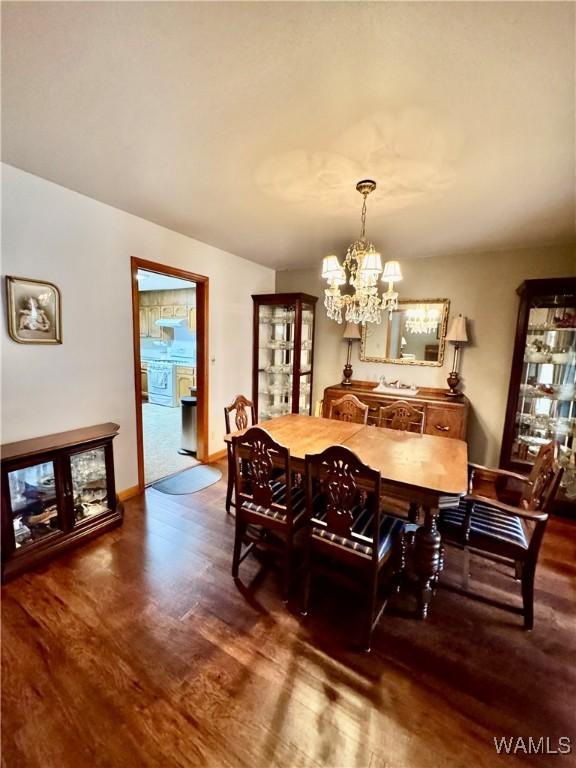 dining area with a chandelier and dark hardwood / wood-style flooring