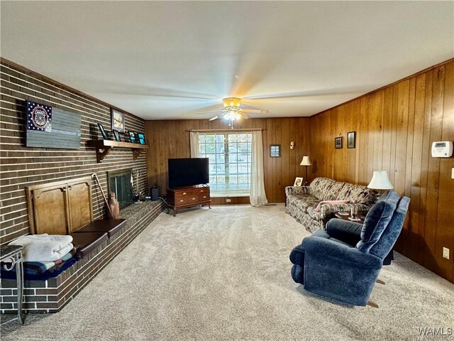 carpeted living room featuring a fireplace, ceiling fan, and wood walls