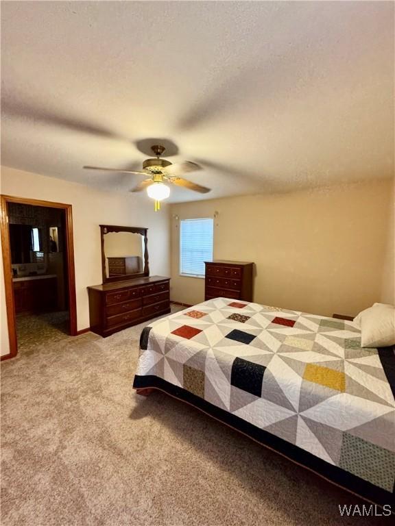 bedroom with light carpet, a textured ceiling, and ceiling fan