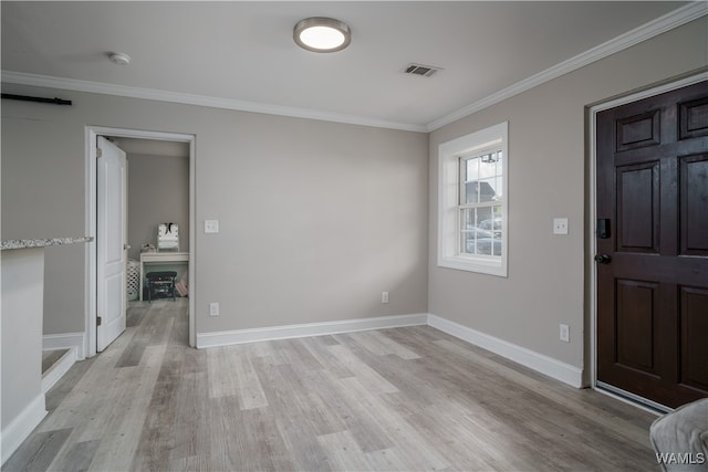 entrance foyer with ornamental molding and light wood-type flooring