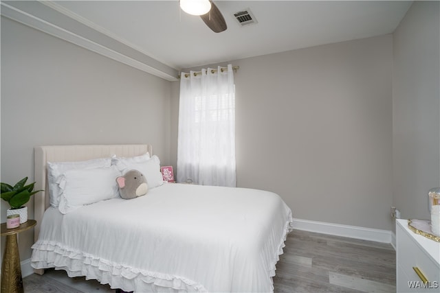 bedroom with ceiling fan and wood-type flooring