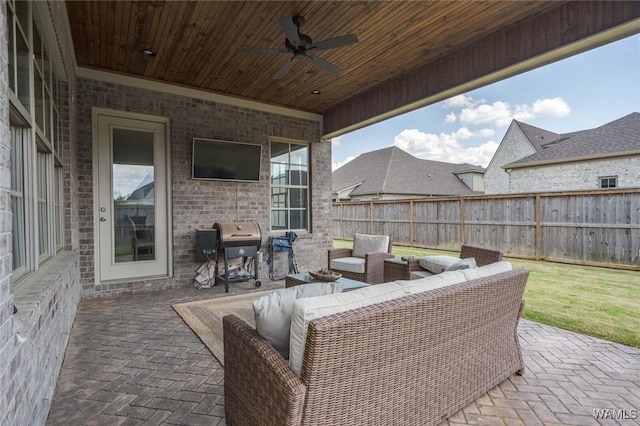 view of patio featuring an outdoor hangout area, a ceiling fan, a fenced backyard, and area for grilling