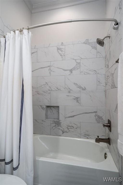 bathroom featuring ornamental molding and shower / bath combo with shower curtain