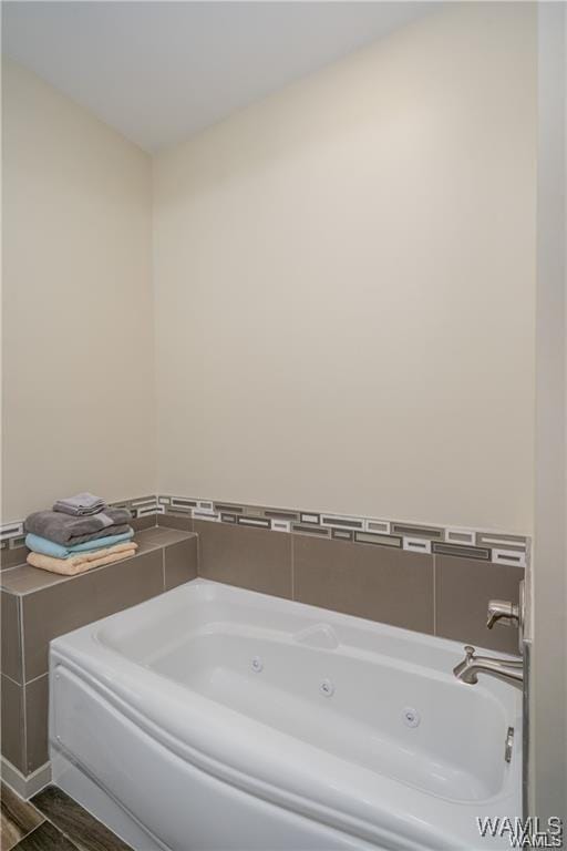 702 Gene Stallings Ave, Tuscaloosa, AL 35401 - full bath featuring a jetted tub and wood finished floors