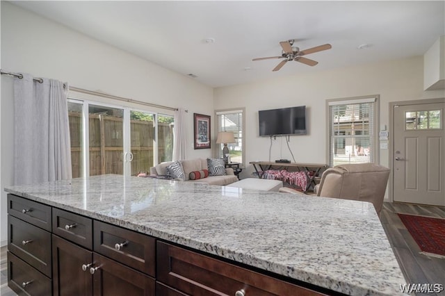 702 Gene Stallings Ave, Tuscaloosa, AL 35401 - kitchen with a ceiling fan, light stone countertops, dark wood-type flooring, dark brown cabinets, and open floor plan