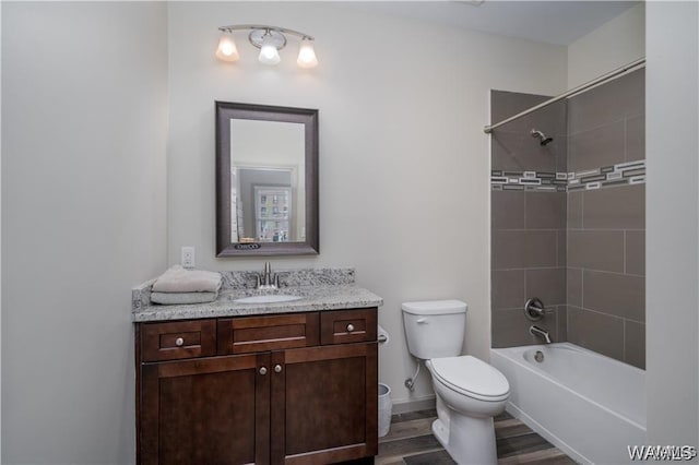 702 Gene Stallings Ave, Tuscaloosa, AL 35401 - bathroom with toilet, wood finished floors, shower / bath combination, baseboards, and vanity