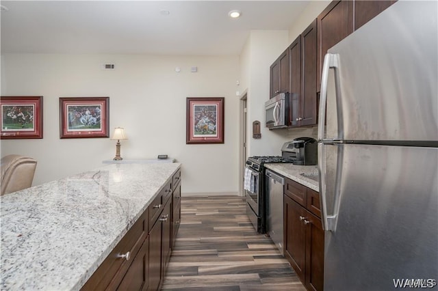 702 Gene Stallings Ave, Tuscaloosa, AL 35401 - kitchen with light stone countertops, visible vents, dark wood finished floors, stainless steel appliances, and dark brown cabinets