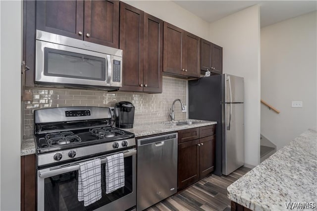 702 Gene Stallings Ave, Tuscaloosa, AL 35401 - kitchen featuring backsplash, dark brown cabinetry, dark wood-style flooring, stainless steel appliances, and a sink
