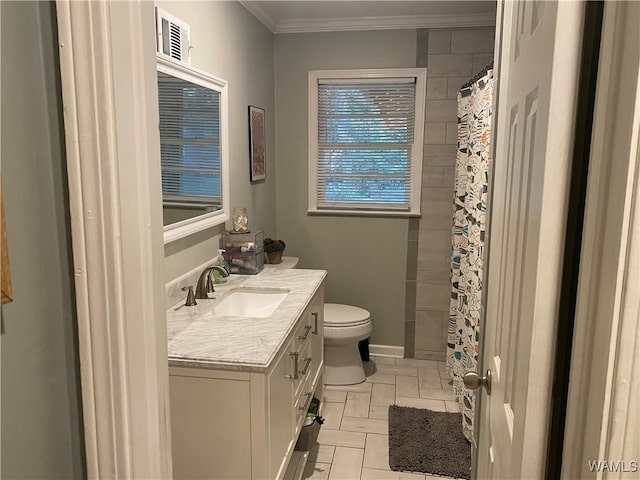 bathroom with vanity, toilet, and crown molding