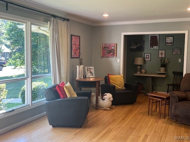 sitting room featuring light wood-type flooring and crown molding