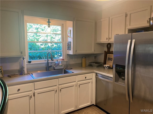 kitchen featuring decorative backsplash, white cabinetry, sink, and appliances with stainless steel finishes