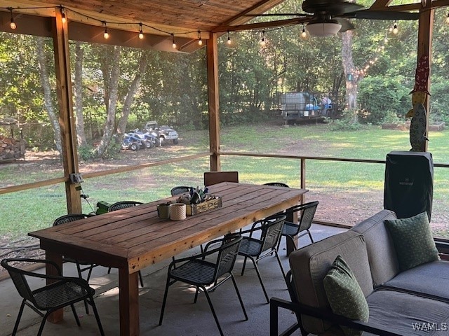 sunroom with ceiling fan and wood ceiling