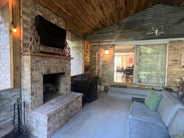 living room with a large fireplace, wooden ceiling, and vaulted ceiling