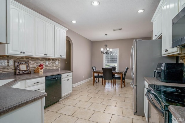 kitchen with dishwasher, dark countertops, hanging light fixtures, white cabinetry, and backsplash