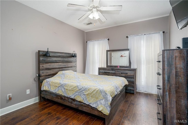 bedroom featuring dark wood-style floors, baseboards, visible vents, and a ceiling fan