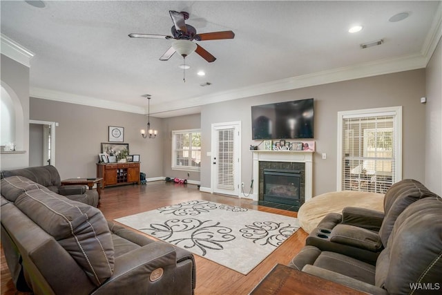 living room featuring dark wood-style flooring, crown molding, and a tiled fireplace