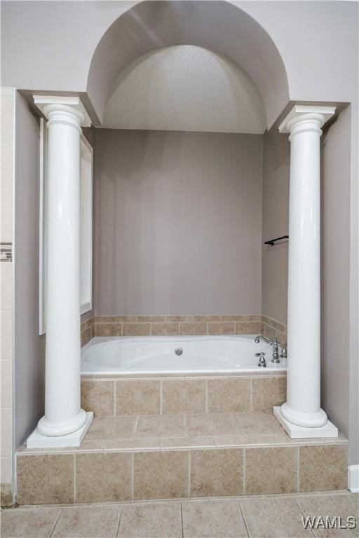 full bathroom with decorative columns and tile patterned floors