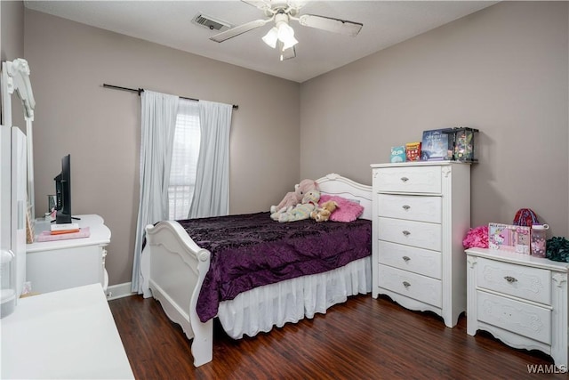 bedroom featuring ceiling fan, visible vents, and dark wood finished floors