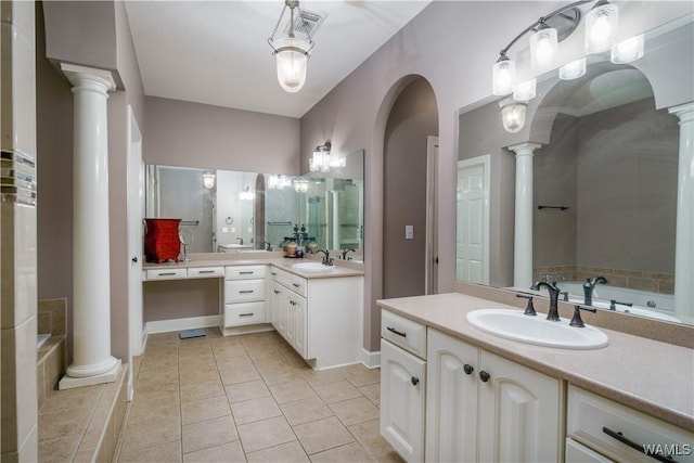 full bath with a sink, ornate columns, and a bath