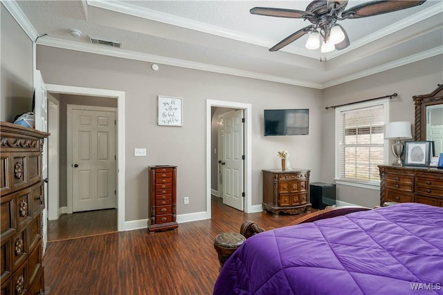 bedroom featuring baseboards, dark wood-type flooring, visible vents, and crown molding