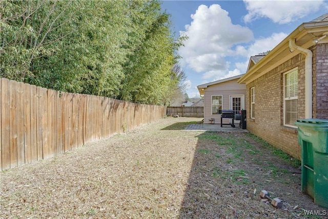 view of yard with a patio area and a fenced backyard