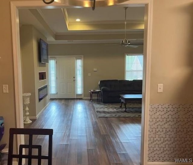 foyer entrance featuring dark hardwood / wood-style floors, ceiling fan, and ornamental molding