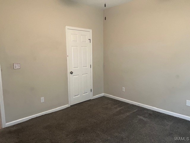 empty room with dark colored carpet