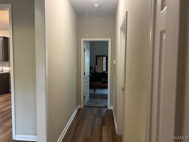 corridor featuring dark hardwood / wood-style floors