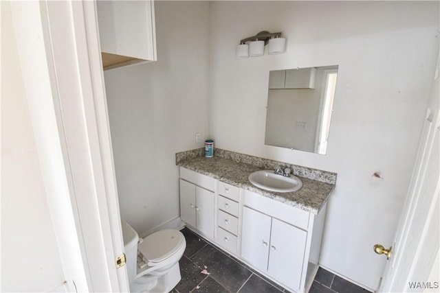 bathroom featuring vanity and toilet