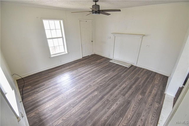 unfurnished bedroom with ceiling fan, dark hardwood / wood-style flooring, and a textured ceiling