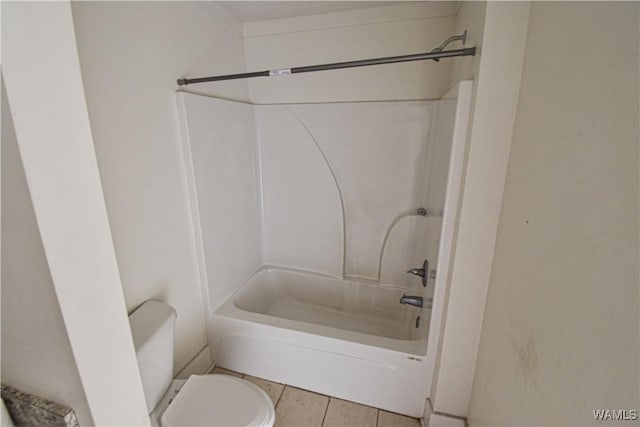 bathroom featuring tile patterned flooring, shower / bathtub combination, and toilet