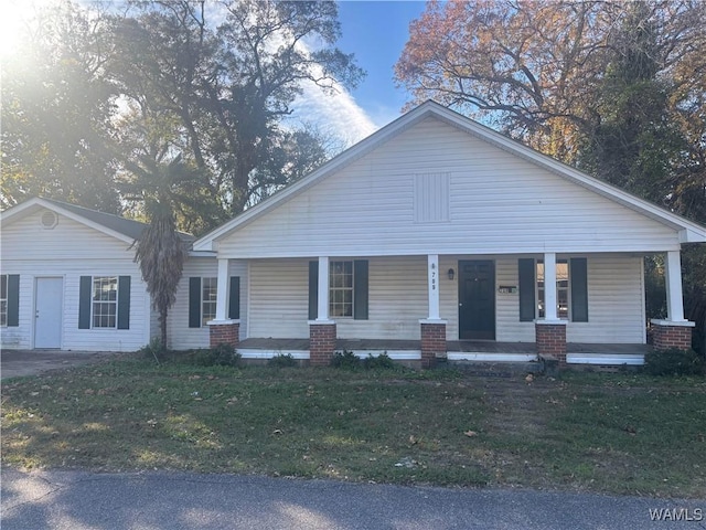 view of front of property with covered porch and a front yard