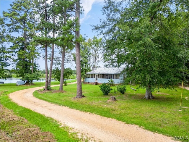 view of property's community with a yard and a water view