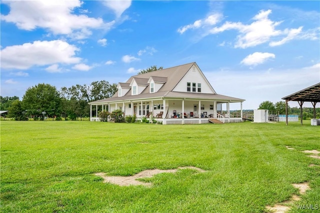 rear view of house with a lawn and covered porch