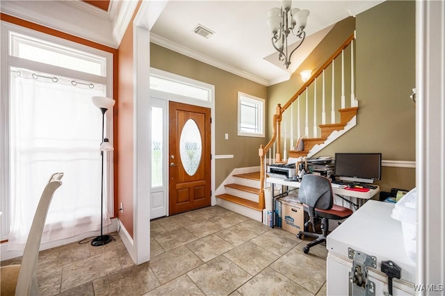 foyer with ornamental molding and a notable chandelier