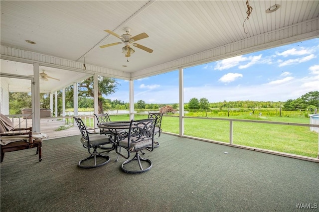 sunroom featuring ceiling fan