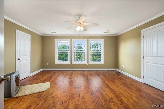 unfurnished room with dark hardwood / wood-style floors, ceiling fan, and crown molding