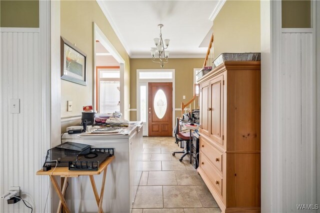 entrance foyer featuring light tile patterned floors and ornamental molding