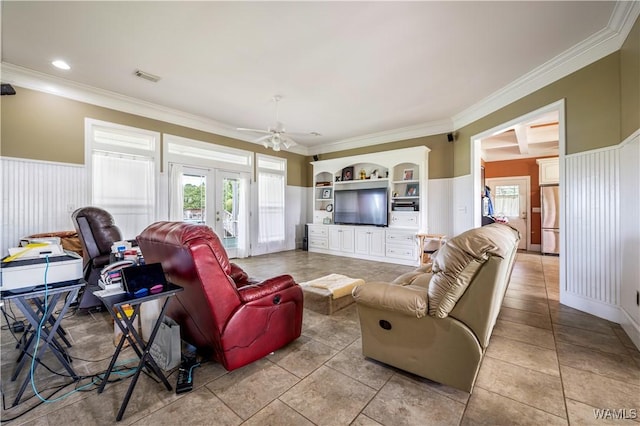 tiled living room featuring built in shelves, french doors, ceiling fan, and ornamental molding