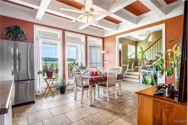 tiled dining space with beamed ceiling, ornamental molding, ceiling fan with notable chandelier, and coffered ceiling