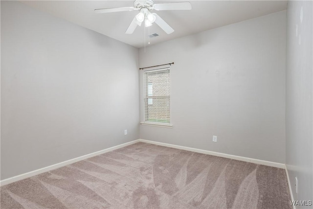 empty room featuring carpet, visible vents, and baseboards